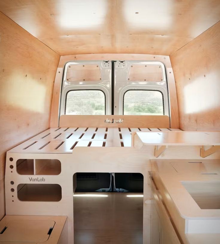 the interior of a small camper with two windows on each side and no roof