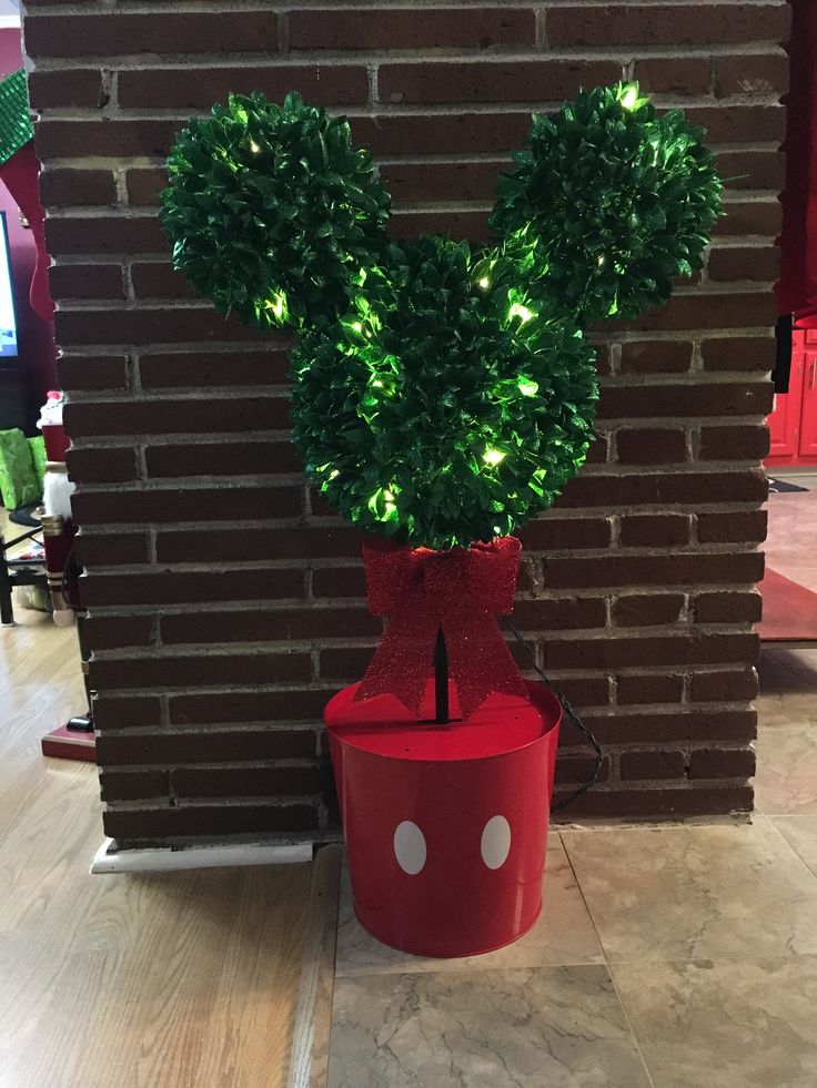 a mickey mouse topiary in a red pot