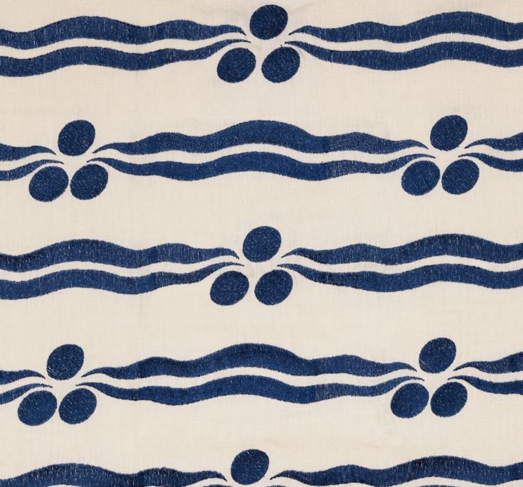 a blue and white striped fabric with circles on the top, lines in the middle