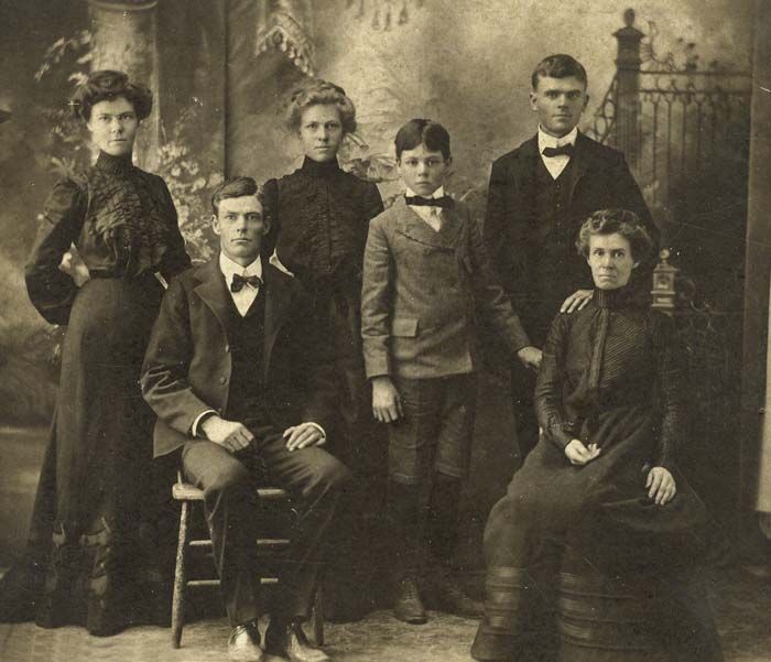 an old black and white photograph of a family posing for a photo in the early 1900's