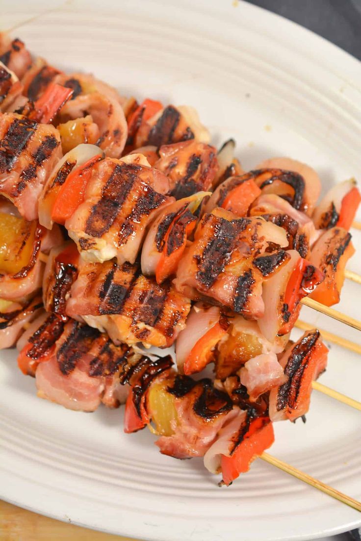 chicken and vegetable skewers on a white plate