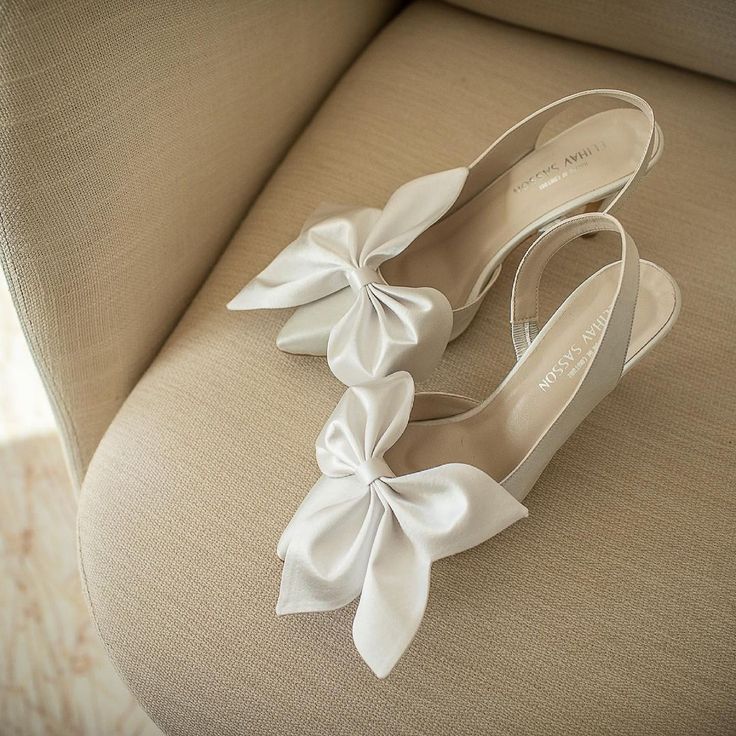 a pair of white shoes sitting on top of a couch