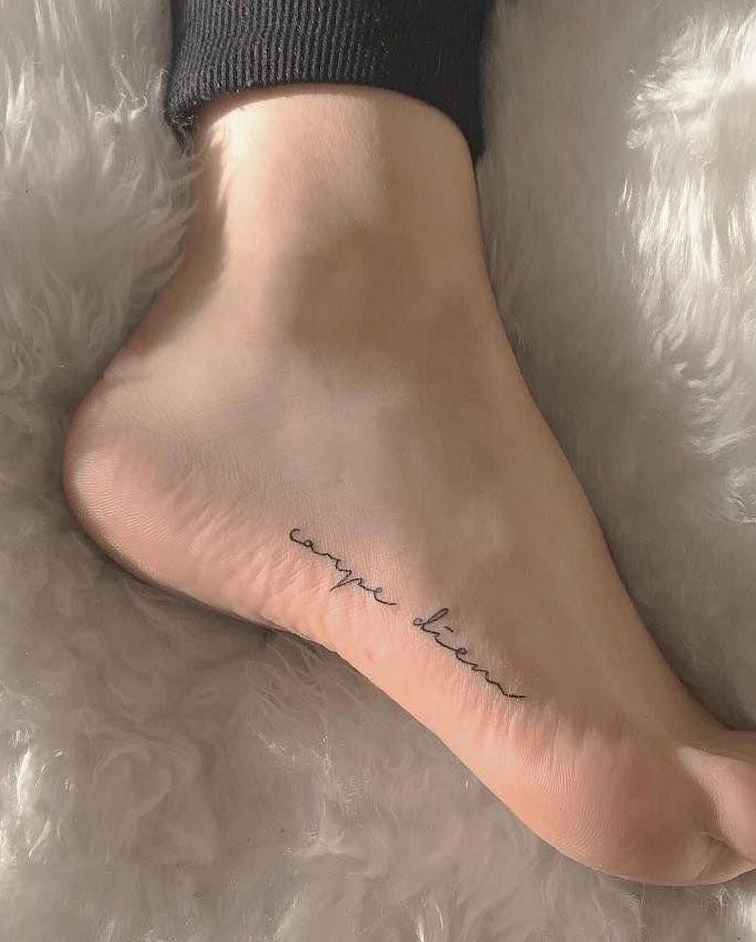 a woman's foot with a tattoo that says, love is in the air