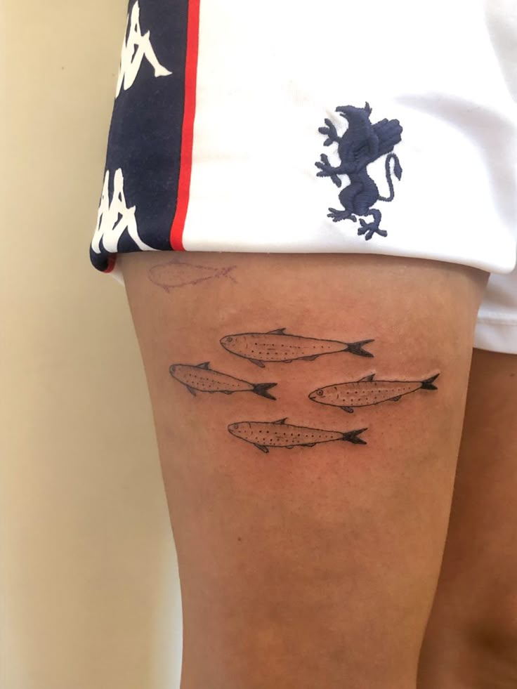 a woman's thigh with fish on it