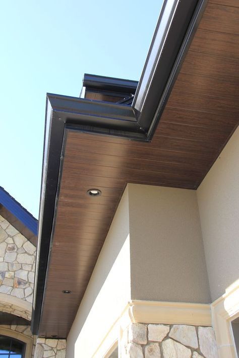 an outside view of a house with a skylight and stone building in the background