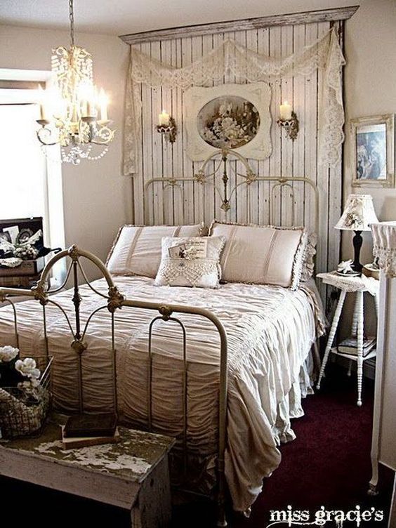 a bed room with a neatly made bed and a chandelier