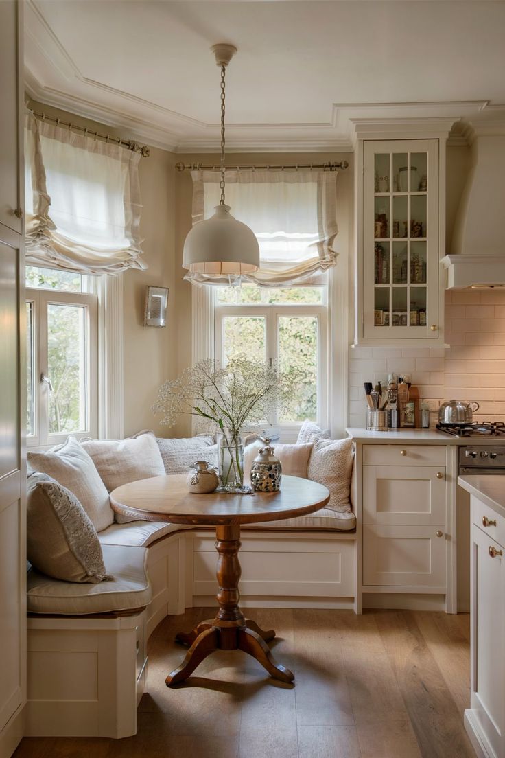 a kitchen with a table, window seat and bench in the middle of the room