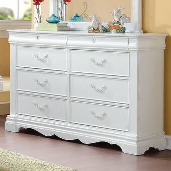 a white dresser in a room with yellow walls