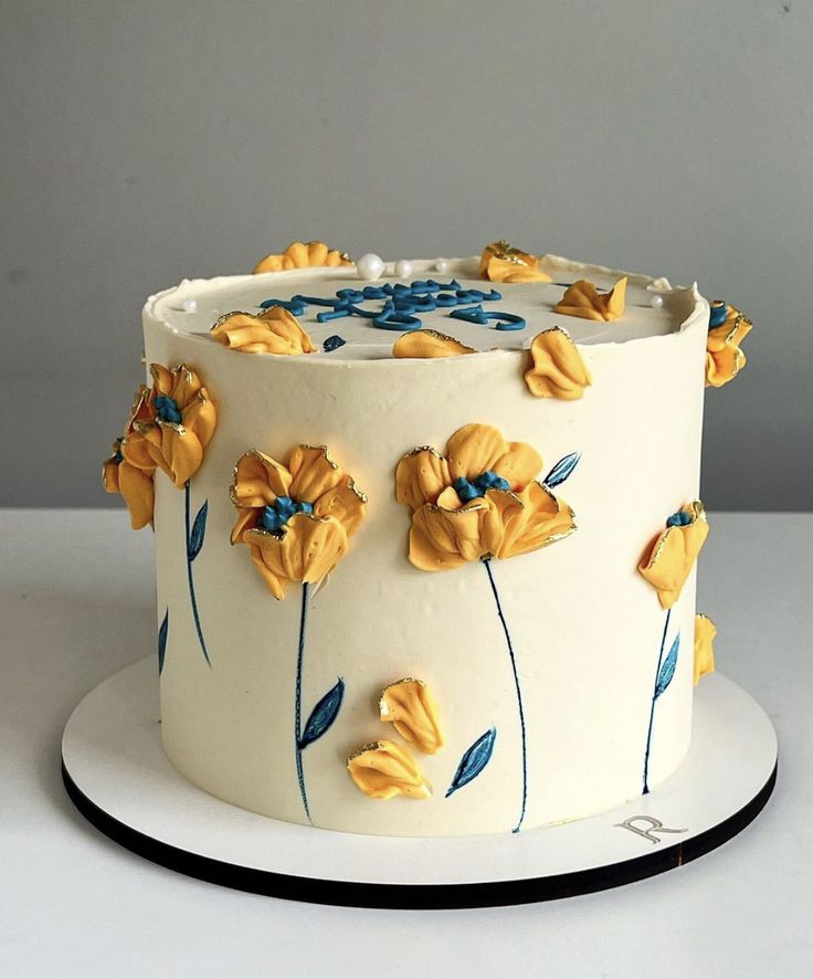 a white cake with yellow flowers on it