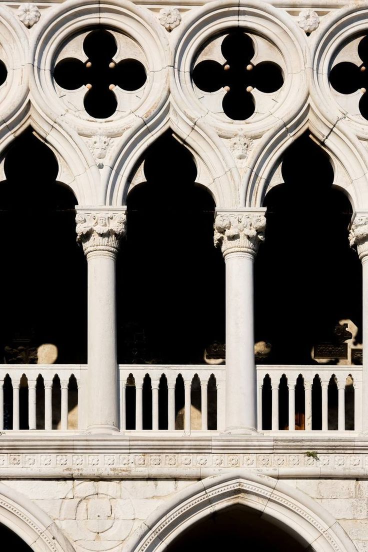 an ornate building with white pillars and arches