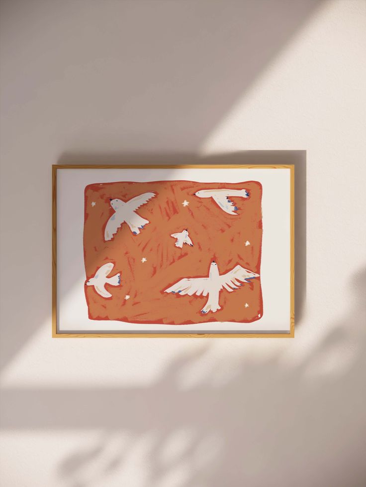 an orange and white painting hanging on the wall