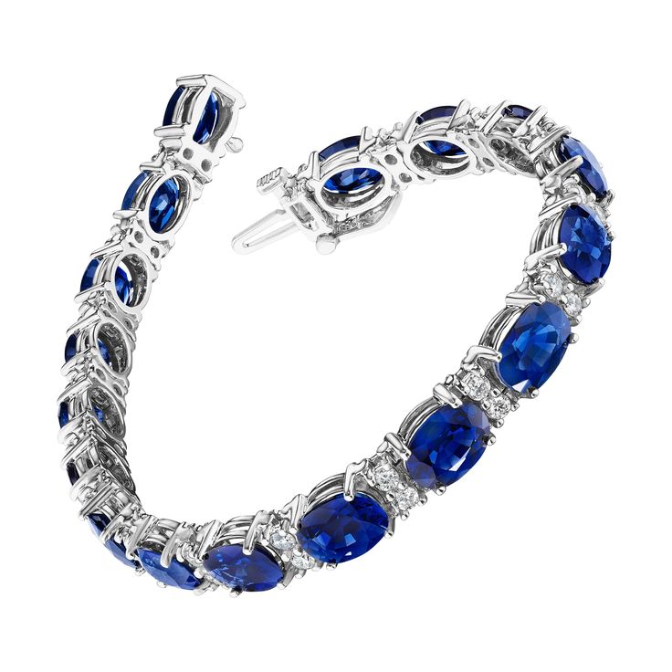 • 18KT White Gold • 22.99 Carats • 7” Long • Number of Sapphires: 17 • Carat Weight: 21.70ctw • Stone Size: 8.0 x 6.0mm • Number of Round Diamonds: 34 • Carat Weight: 1.29ctw • A beautiful row of oval cut deep blue sapphires and white round brilliant cut diamonds encircle the wrist in this bracelet, set in 18KT white gold. The bracelet measures 7" in length and has a combining total weight of approximately 22.99 carats. Each stone has been carefully matched and set by hand in New York City. Round Diamond Bracelet, Modern Bracelets, Round Brilliant Cut Diamond, Oval Cut, Yorkie, Deep Blue, Round Diamond, Blue Sapphire, Diamond Bracelet