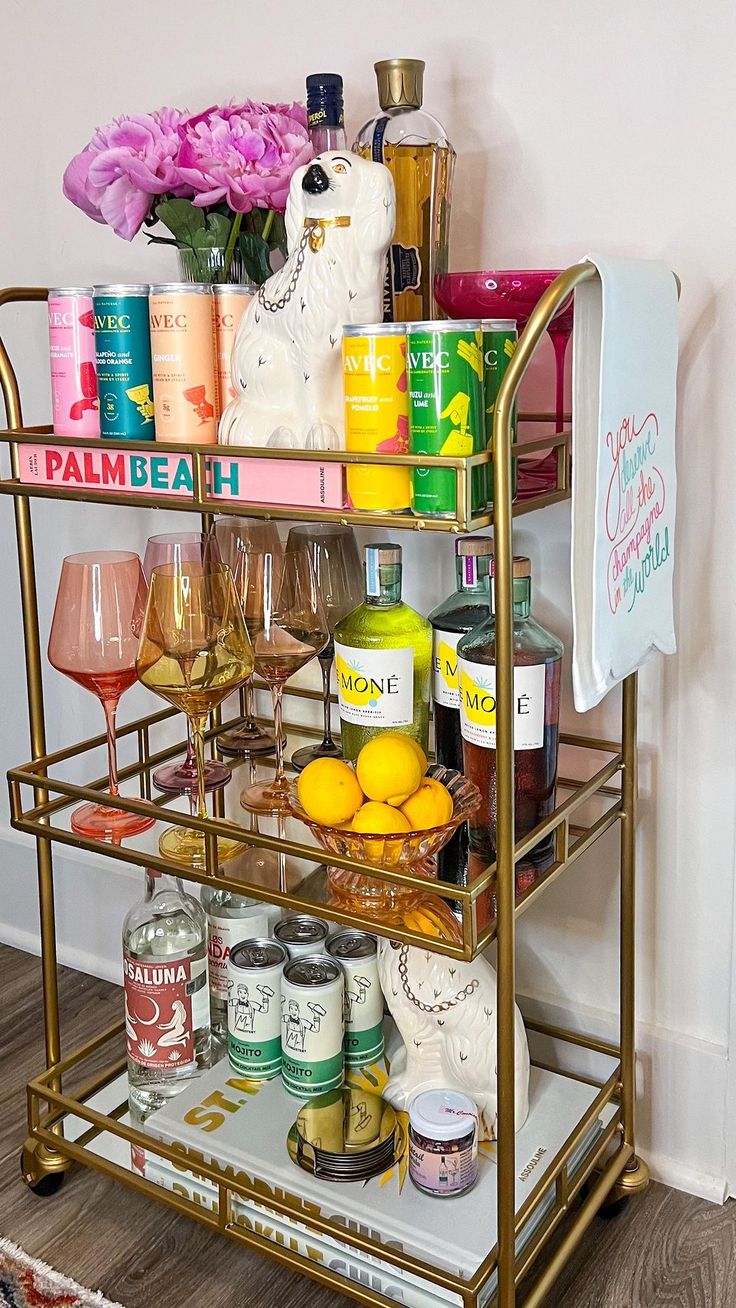 a bar cart filled with lots of bottles and glasses