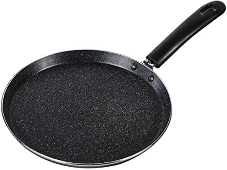 an empty frying pan on a white background