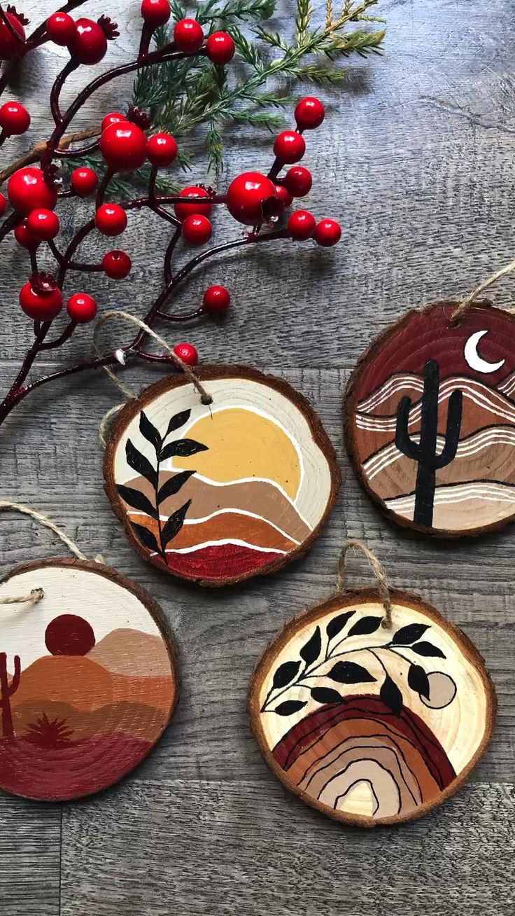 four wooden ornaments are hanging on a table