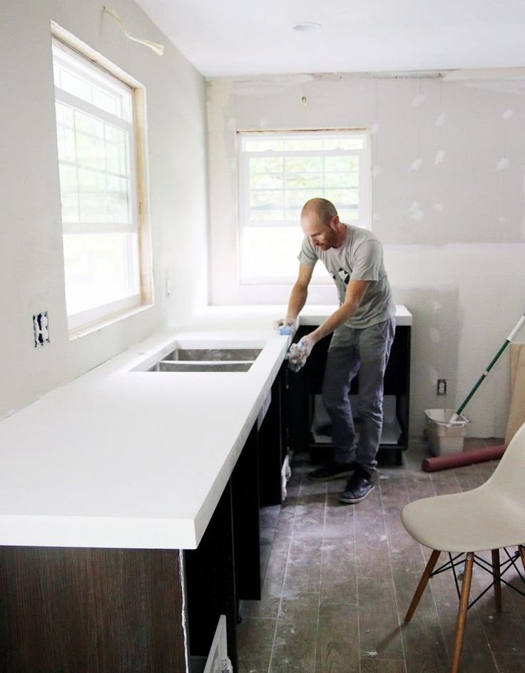 a man is sanding the counter in his kitchen