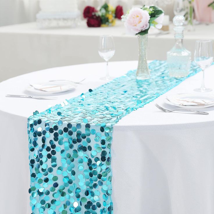 the table runner is decorated with blue sequins