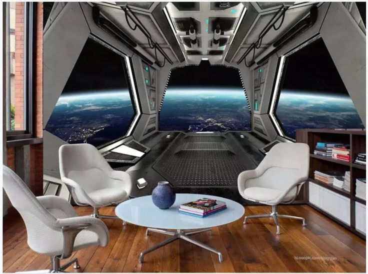 the interior of a space station with two chairs and a table in front of it