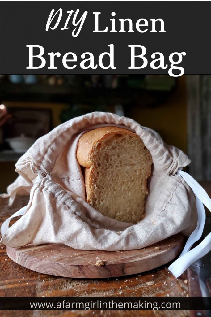 a loaf of bread sitting on top of a wooden cutting board next to a bag