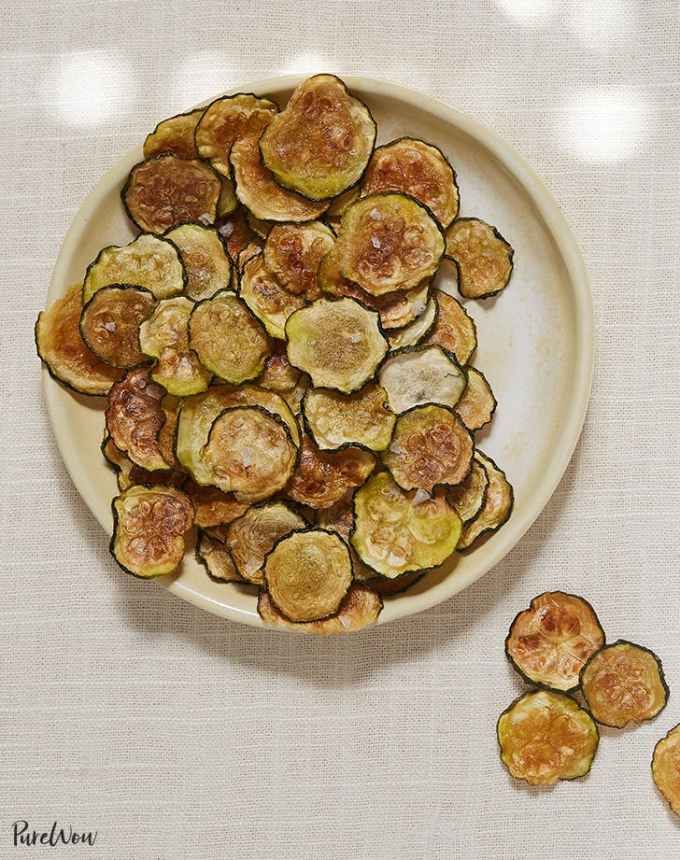 a white plate topped with sliced zucchini chips