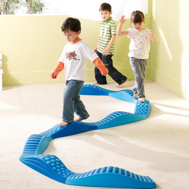 three children are playing on an interactive playground