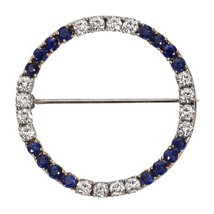 This is part of Chairish’s Fine Jewelry assortment.  Introducing our exquisite Vintage Diamond and Sapphire Circle Brooch, a true testament to timeless elegance and luxurious craftsmanship. This magnificent piece showcases a harmonious blend of 14 karat white and yellow gold, accentuated by dazzling diamonds and a captivating sapphire. At the heart of this brooch, a brilliant 1.25 carat diamond takes center stage, radiating brilliance and sophistication. Its mesmerizing facets reflect light from Classic Platinum Brooch With Brilliant Cut, Classic Diamond Brooch With Gemstones, Classic Diamond Gemstone Brooches, Luxury Brilliant Cut Brooches For Anniversary, Platinum Brooch Jewelry For Anniversary, Classic Diamond Brilliant Cut Brooch, Classic Diamond Brooch With Brilliant Cut, Classic Diamond Brooches With Brilliant Cut, Evening Platinum Brooch Jewelry