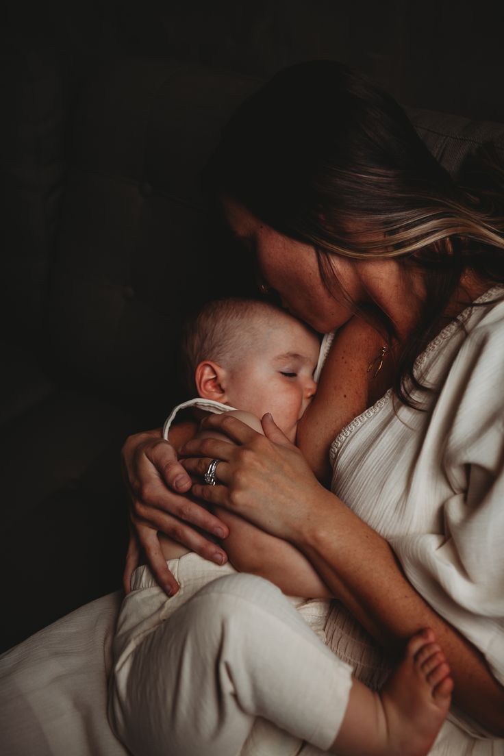 a woman holding a baby in her arms