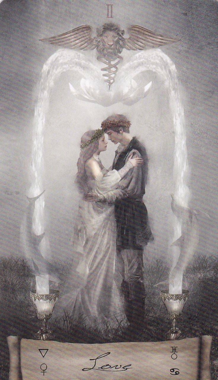 a man and woman standing next to each other in front of an angel wings background