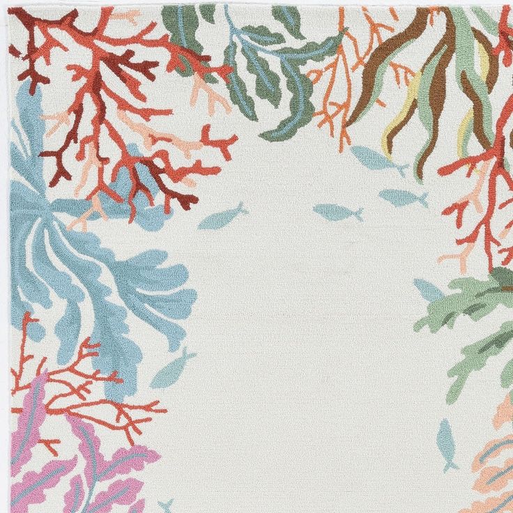 an area rug with various colored leaves and branches on white ground, in front of a light blue background