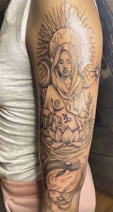 a woman's arm with tattoos on it and an image of a buddha in the middle