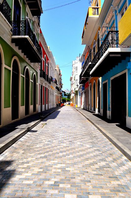 an empty street lined with multicolored buildings