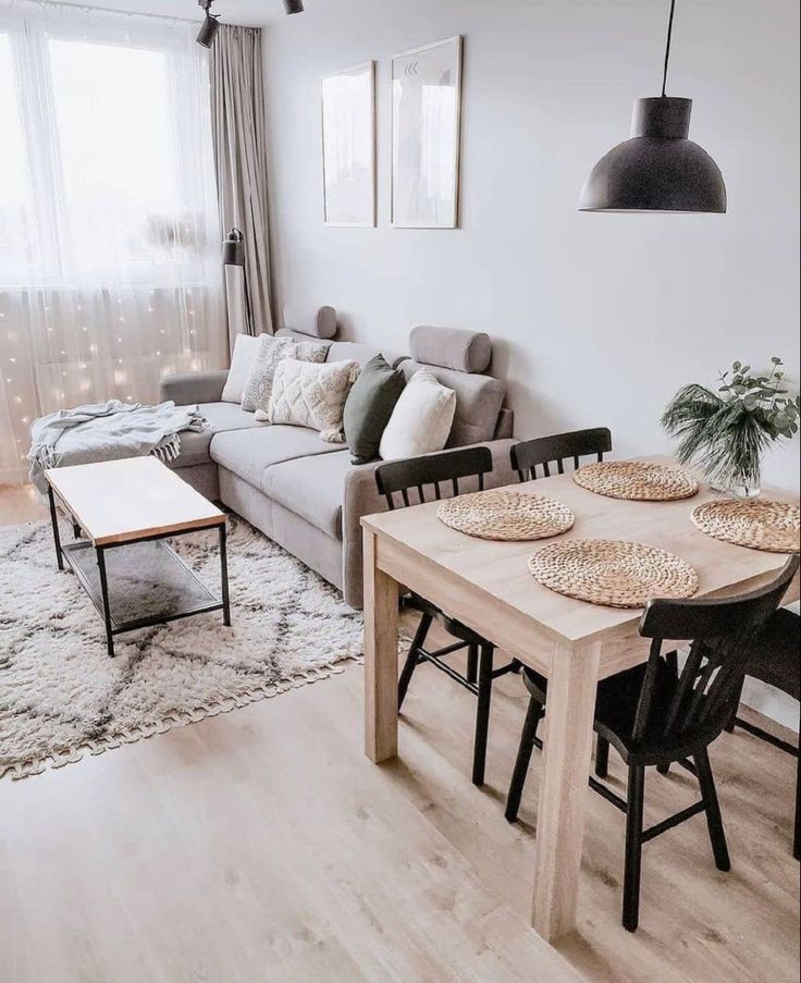 a living room filled with furniture and a wooden table in front of a couches