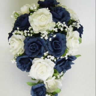 a bridal bouquet with blue and white flowers on it's side, in the shape of a heart