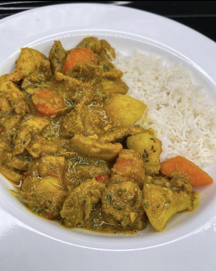 a white plate topped with meat and rice