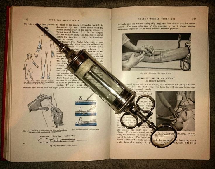 an open book with instructions on how to use a hand held syringe and scissors