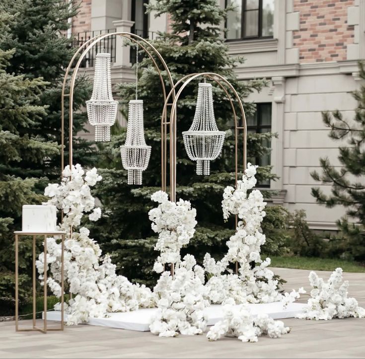 white flowers and chandeliers on display in front of a building