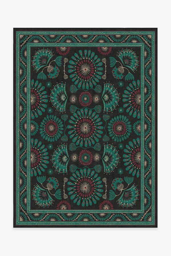 a black and green square rug with an intricate design