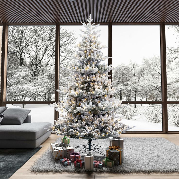 a living room with a christmas tree in the center and presents under it on the floor