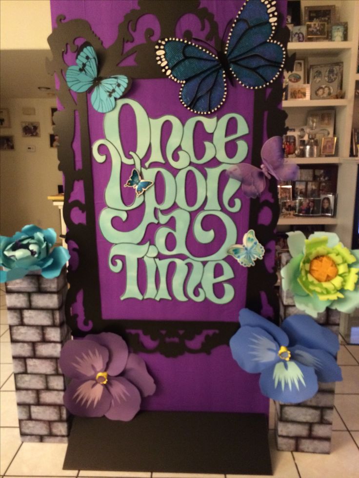 a purple and blue sign with butterflies on it that says peace is the time in front of a brick wall