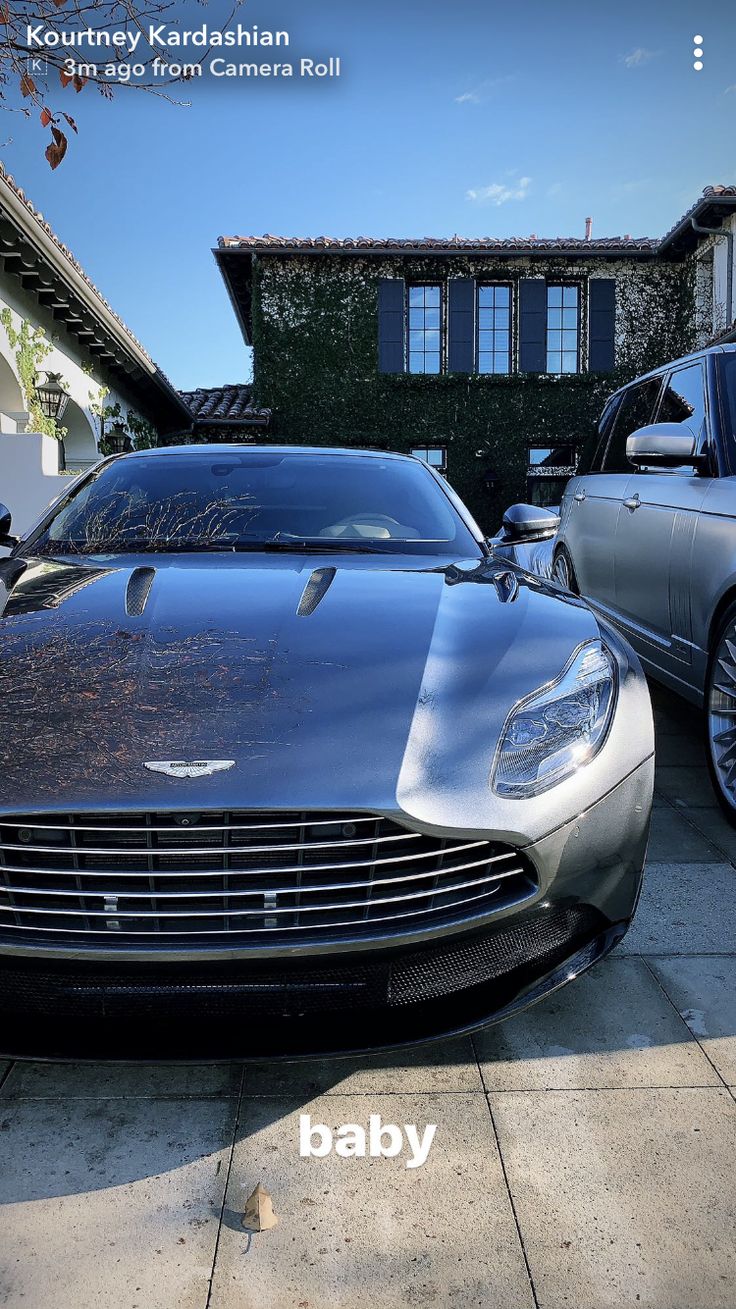 two cars parked next to each other in front of a house with the words baby written on it