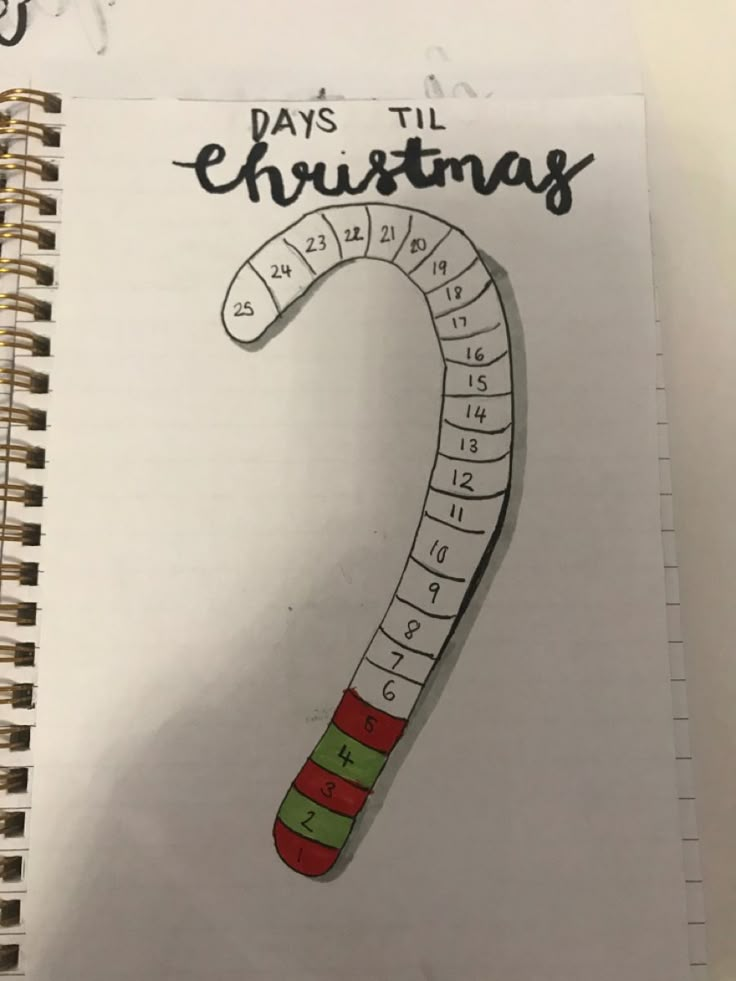 a spiral notebook with a drawing of a christmas candy cane