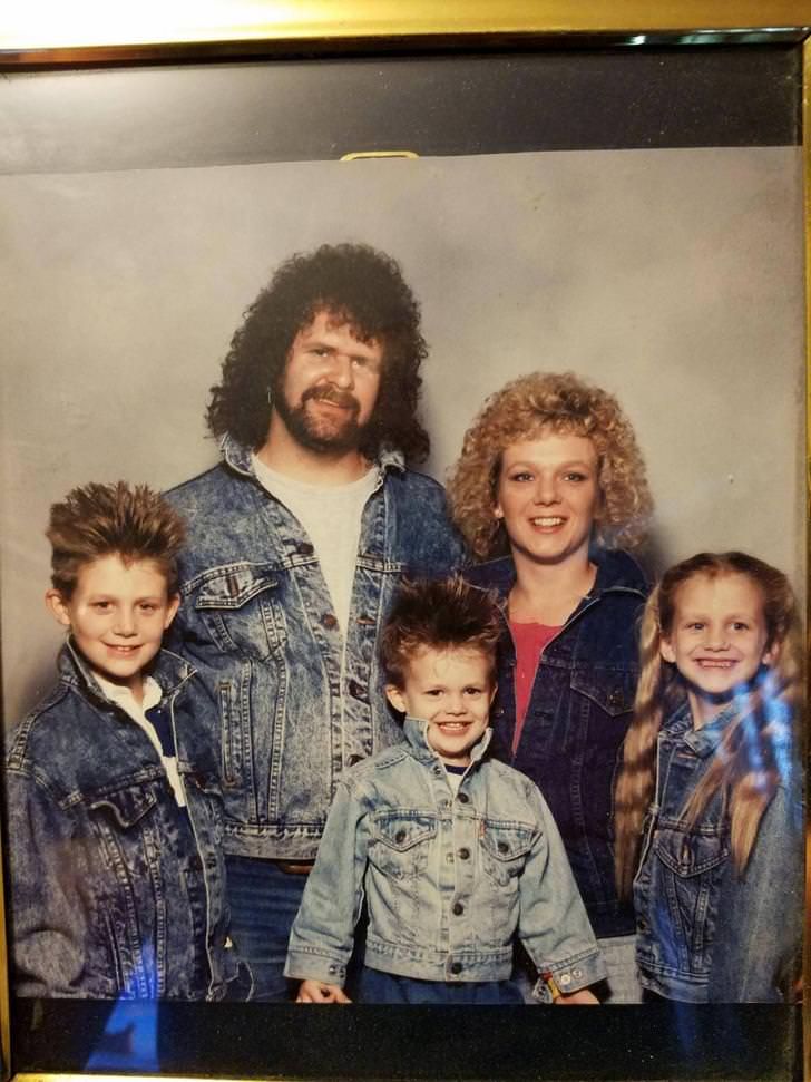 an old photo of a family with two children and one adult standing next to each other