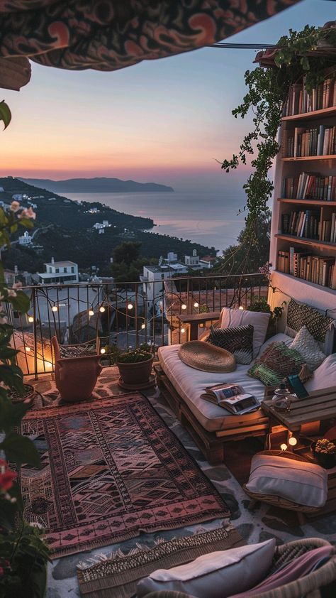 an outdoor seating area with bookshelves, pillows and rugs on the ground