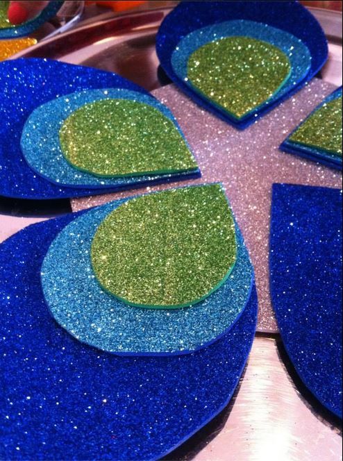 blue and green plates with designs on them are sitting on a counter top in the shape of a flower