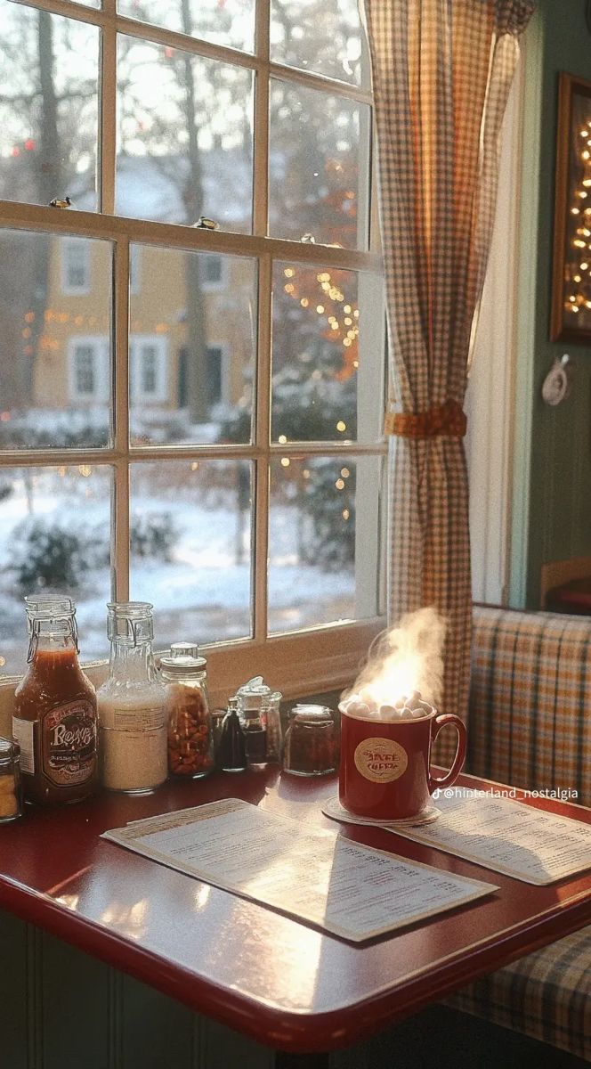 a red table topped with lots of food next to a window covered in frosting