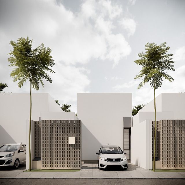 two cars parked next to each other in front of a white building with palm trees