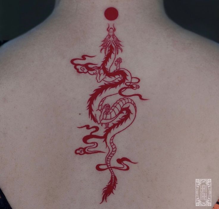 a woman with a dragon tattoo on her back