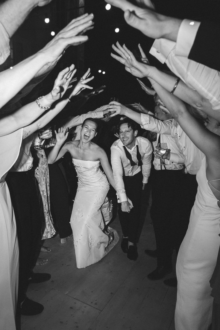 the bride and groom are surrounded by their guests