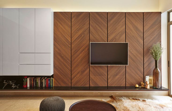 a living room with a television and bookshelf