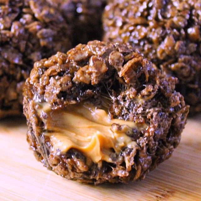 three cookies with cheese and chocolate are on a cutting board, ready to be eaten